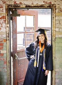high school senior girl in a graduation cap and gown